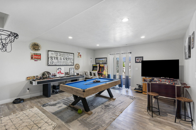7889 Bristlecone Road Eagle Mountain, UT 84005 - Photo 27 of 42 Spacious recreation room featuring wood-finish flooring, recessed lighting, and white walls