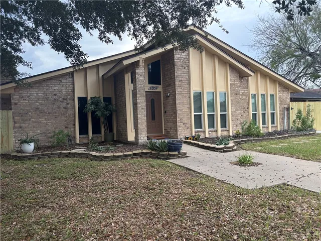 a kitchen with granite countertop stainless steel appliances a sink a refrigerator a stove a microwave and cabinets