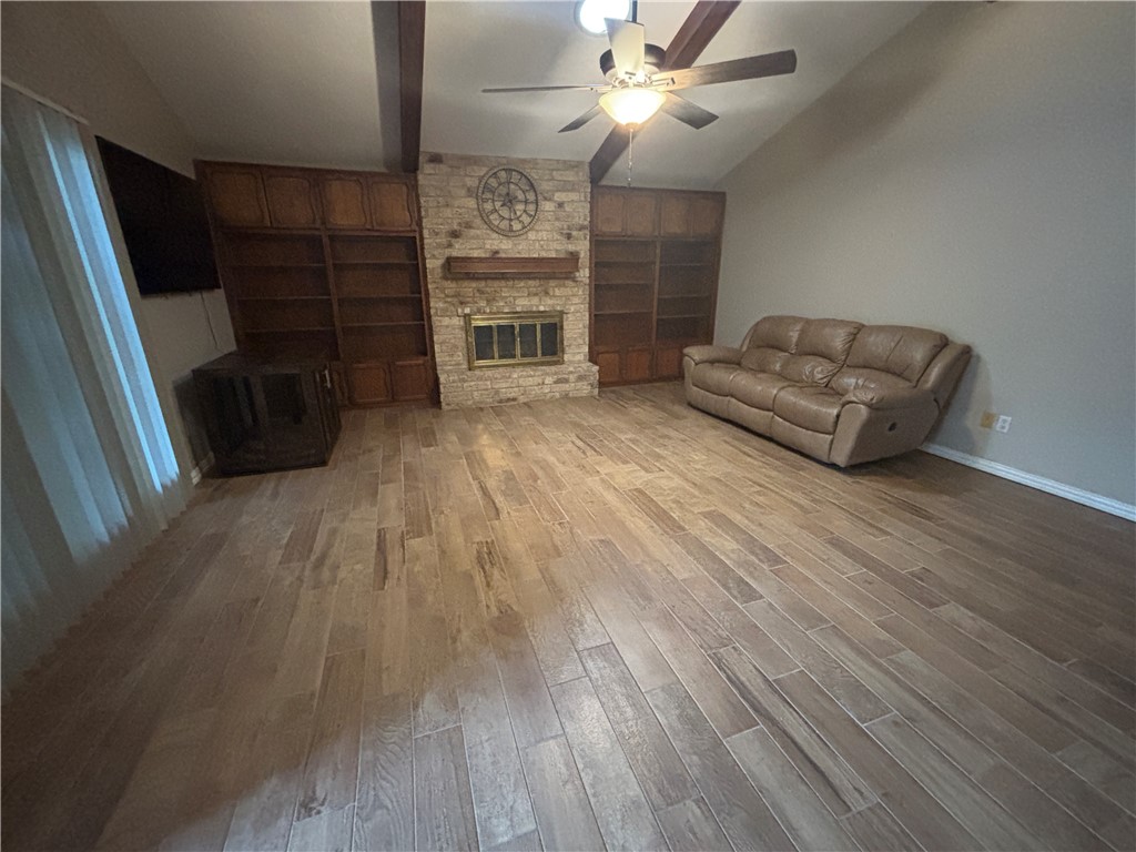 4957 Shadowbend Drive Corpus Christi, TX 78413 - Photo 18 of 35 wooden floor in an empty room with a fireplace
