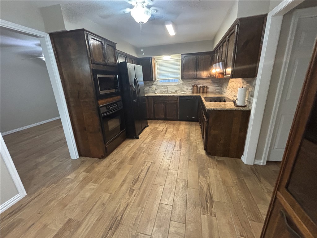 4957 Shadowbend Drive Corpus Christi, TX 78413 - Photo 20 of 35 a kitchen with granite countertop stainless steel appliances a sink a refrigerator a stove a microwave and cabinets