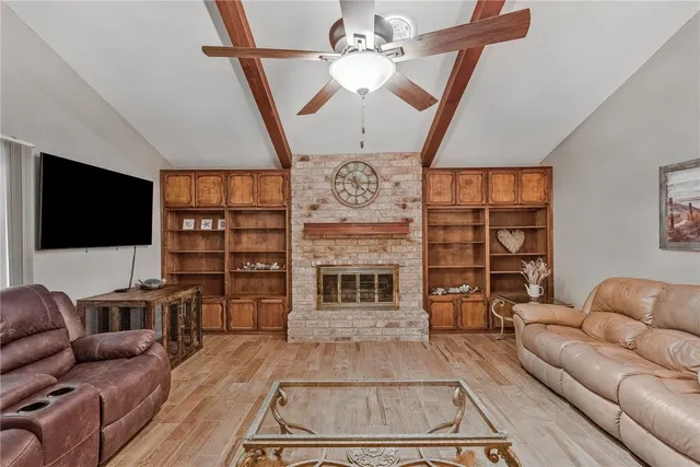 a living room with fireplace furniture and a flat screen tv
