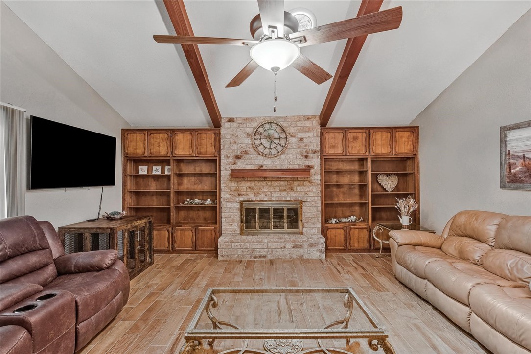 4957 Shadowbend Drive Corpus Christi, TX 78413 - Photo 2 of 35 a living room with fireplace furniture and a flat screen tv