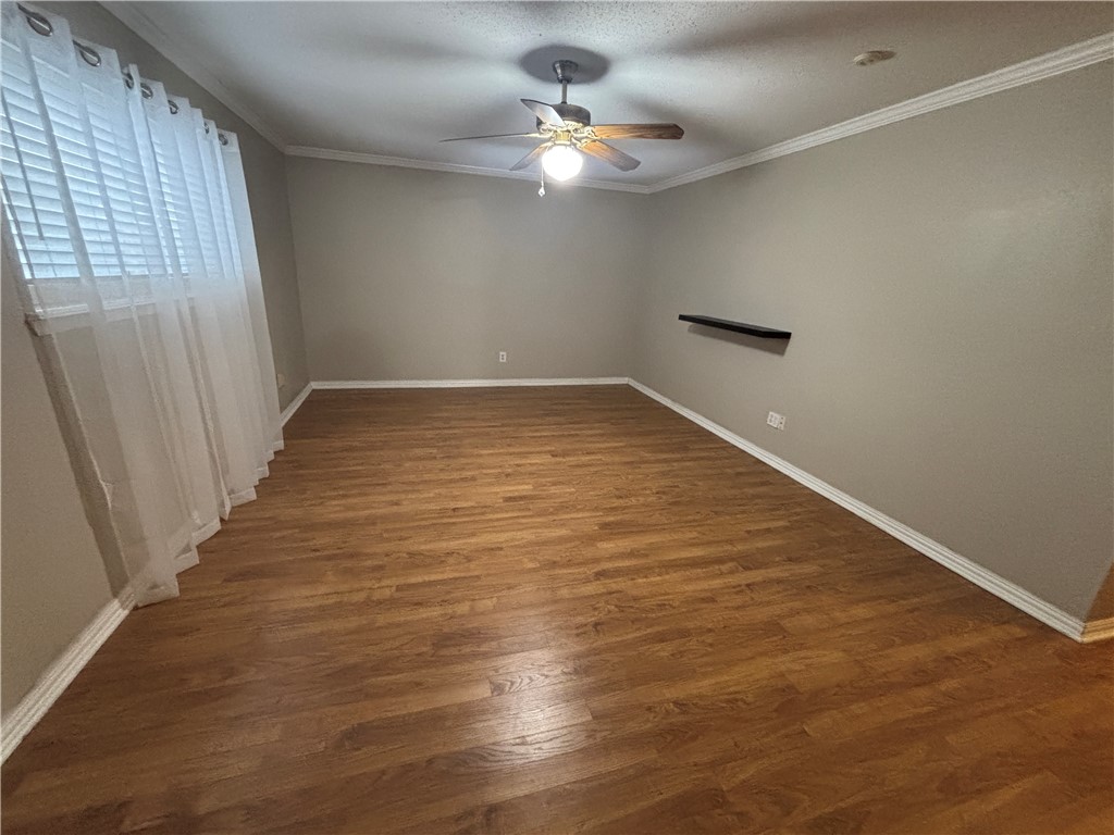 4957 Shadowbend Drive Corpus Christi, TX 78413 - Photo 25 of 35 an empty room with wooden floor and fan