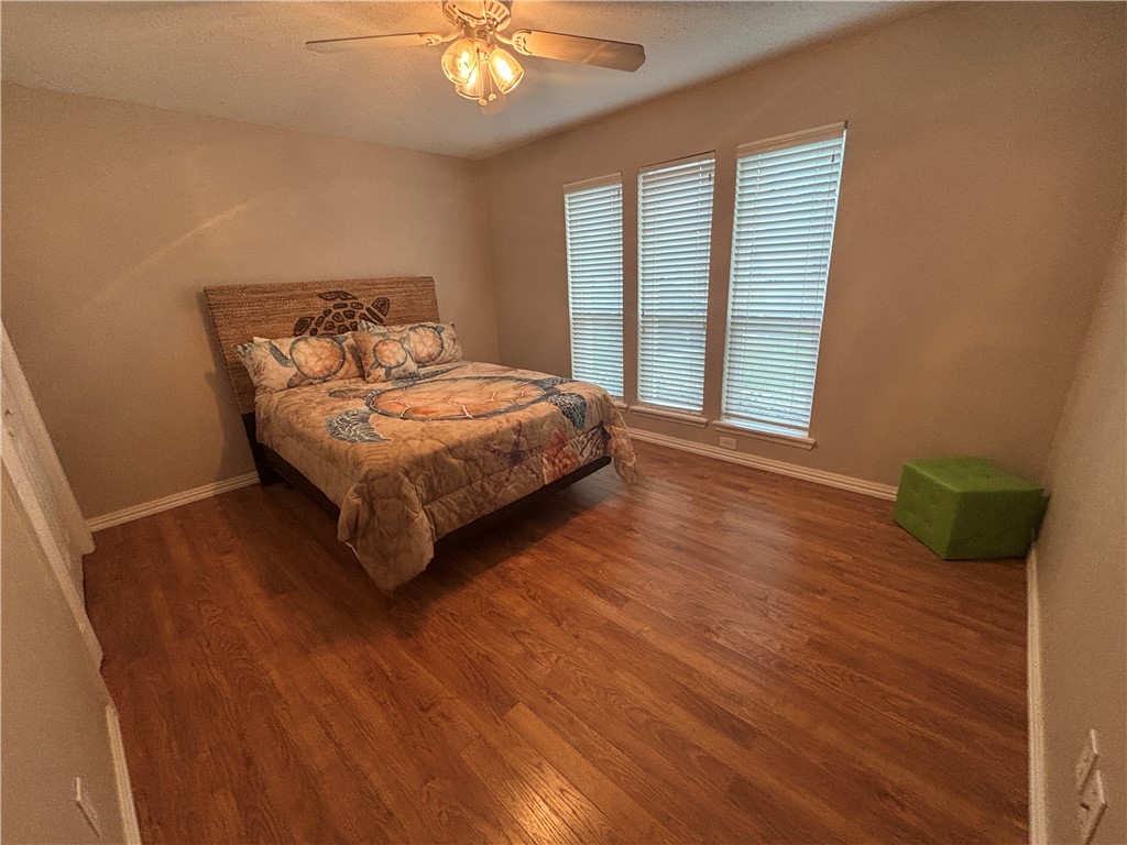 4957 Shadowbend Drive Corpus Christi, TX 78413 - Photo 27 of 35 a bed sitting in a spacious bedroom next to a window