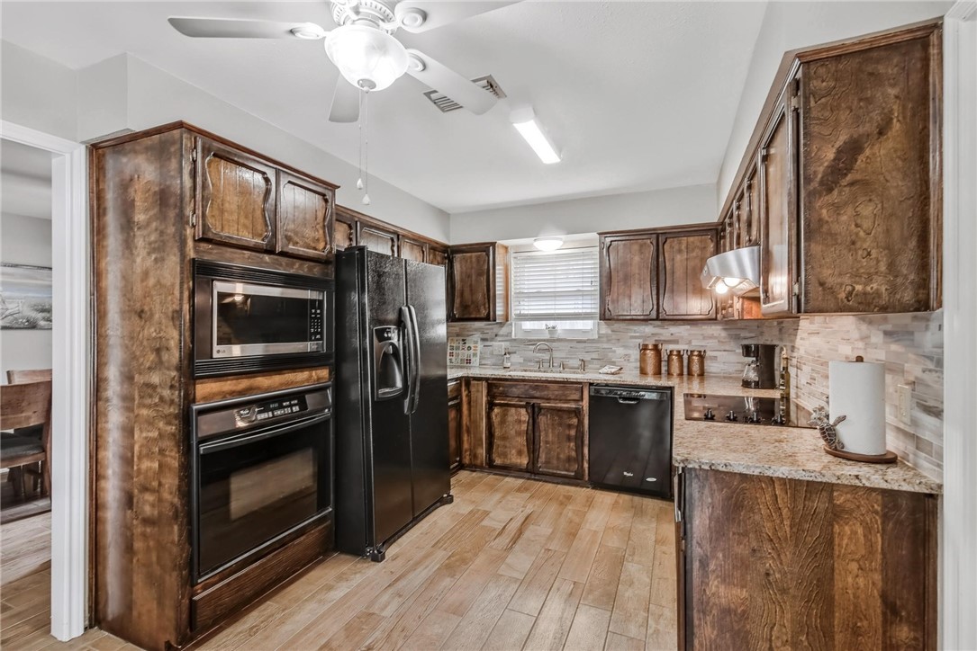 4957 Shadowbend Drive Corpus Christi, TX 78413 - Photo 3 of 35 a kitchen with granite countertop stainless steel appliances and wooden cabinets
