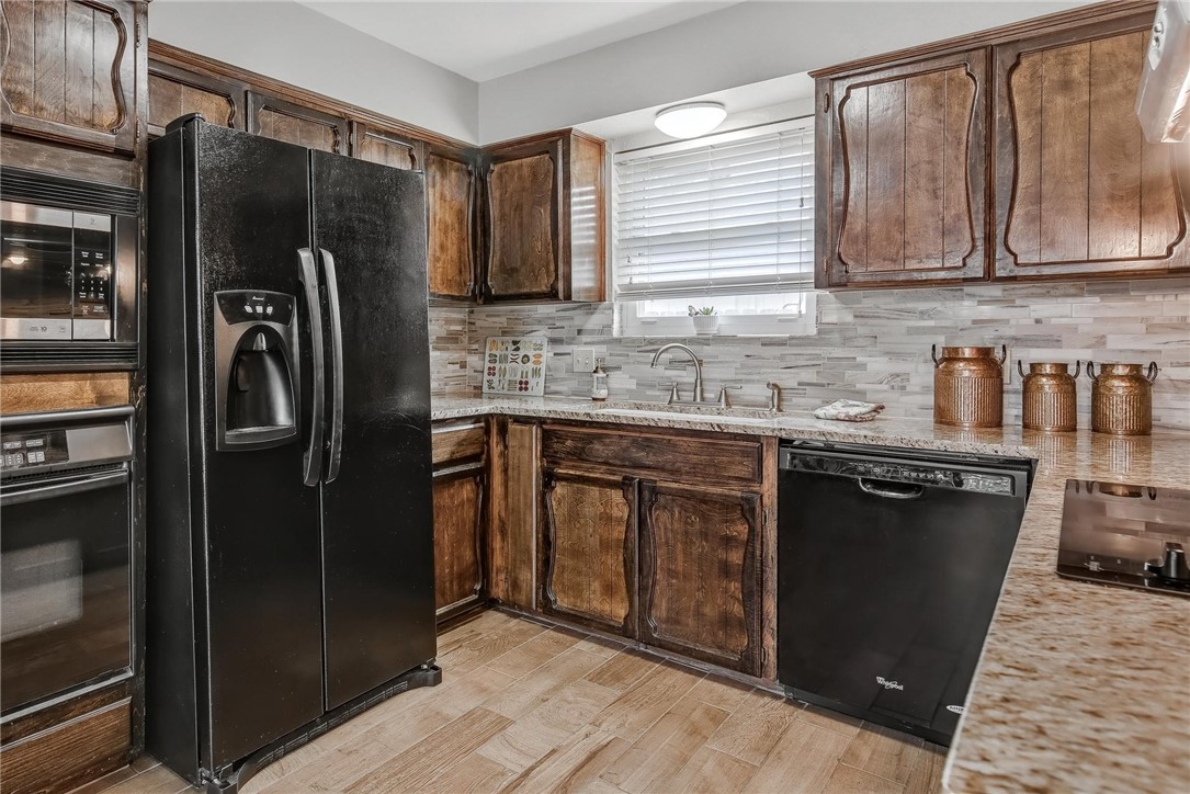 4957 Shadowbend Drive Corpus Christi, TX 78413 - Photo 4 of 35 a kitchen with stainless steel appliances granite countertop a refrigerator and a sink