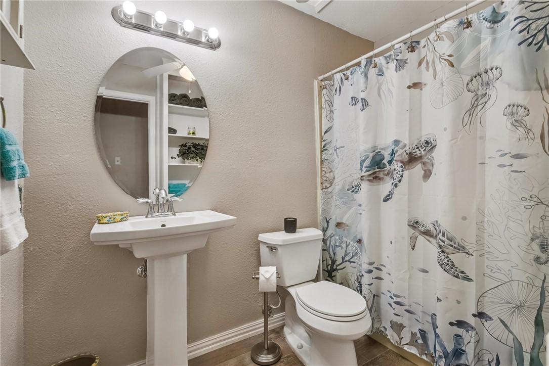 4957 Shadowbend Drive Corpus Christi, TX 78413 - Photo 8 of 35 a bathroom with a sink and mirror with toilet