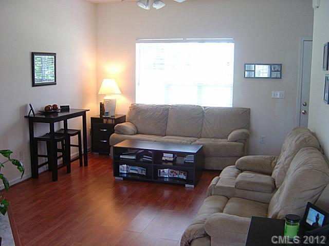 10118 Faires Farm Road Charlotte, NC 28213 - Photo 2 of 13 a living room with furniture a wooden floor and a large window