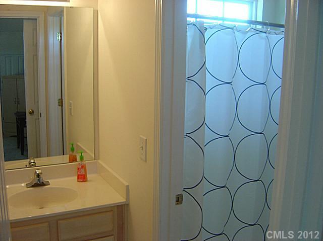 10118 Faires Farm Road Charlotte, NC 28213 - Photo 11 of 13 a bathroom with a sink and a mirror