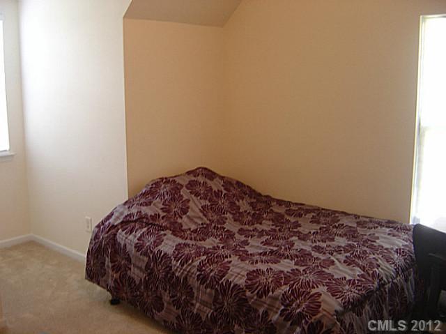10118 Faires Farm Road Charlotte, NC 28213 - Photo 12 of 13 a bed sitting in a bedroom next to a window
