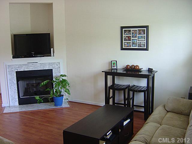 10118 Faires Farm Road Charlotte, NC 28213 - Photo 3 of 13 a living room with furniture a flat screen tv and a fireplace
