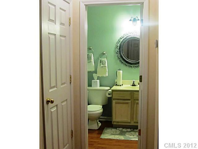10118 Faires Farm Road Charlotte, NC 28213 - Photo 5 of 13 a bathroom with a toilet a sink and a mirror