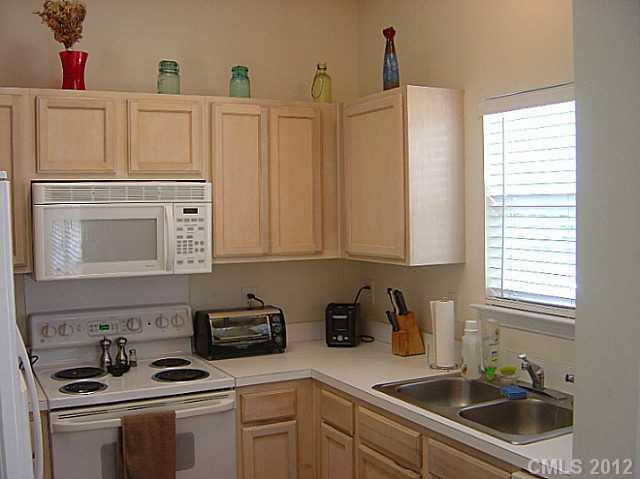 10118 Faires Farm Road Charlotte, NC 28213 - Photo 6 of 13 a kitchen with stainless steel appliances granite countertop a sink stove and cabinets