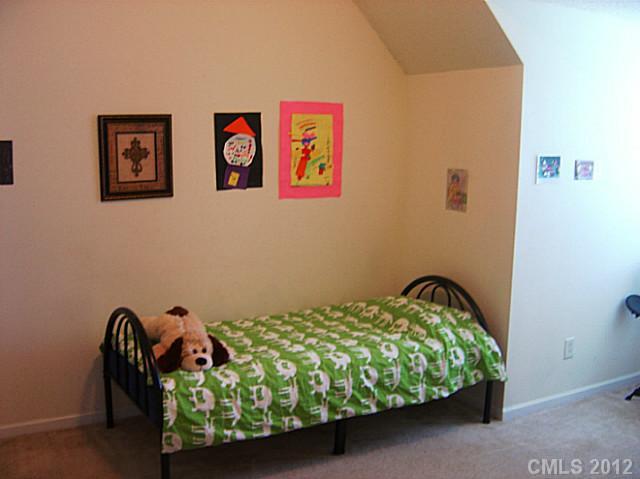 10118 Faires Farm Road Charlotte, NC 28213 - Photo 10 of 13 a bedroom with a bed and a painting on the wall