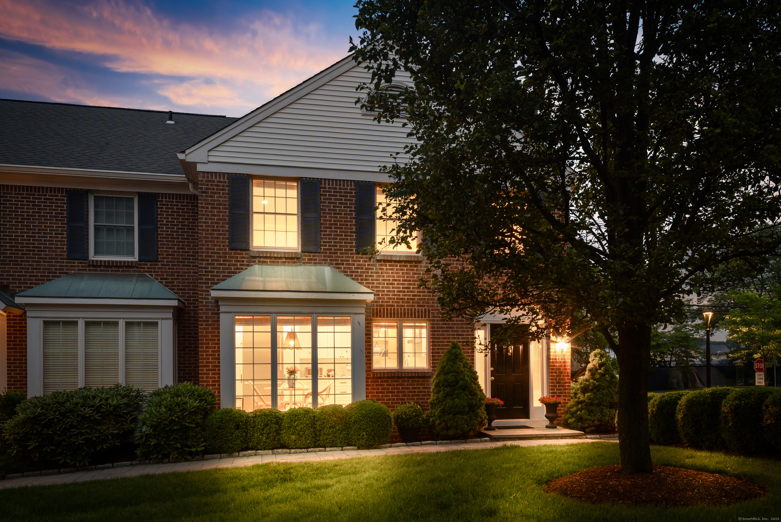 1 Maple Street, Unit 1 New Canaan, CT 06840 - Photo 1 of 1 a front view of a house with a yard