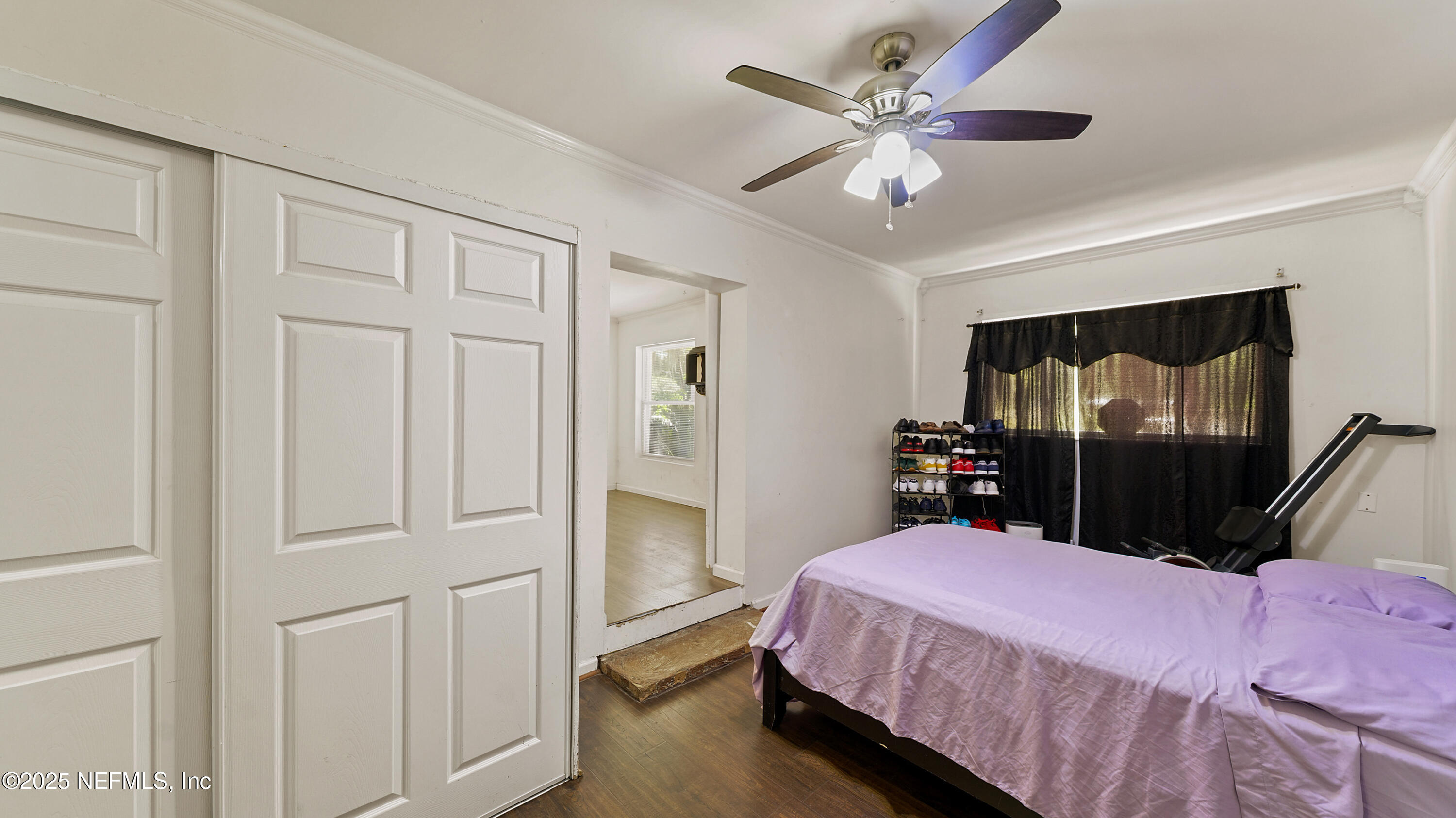 10555 Rutgers Road Jacksonville, FL 32218 - Photo 11 of 25 a bedroom with a bed and a chandelier