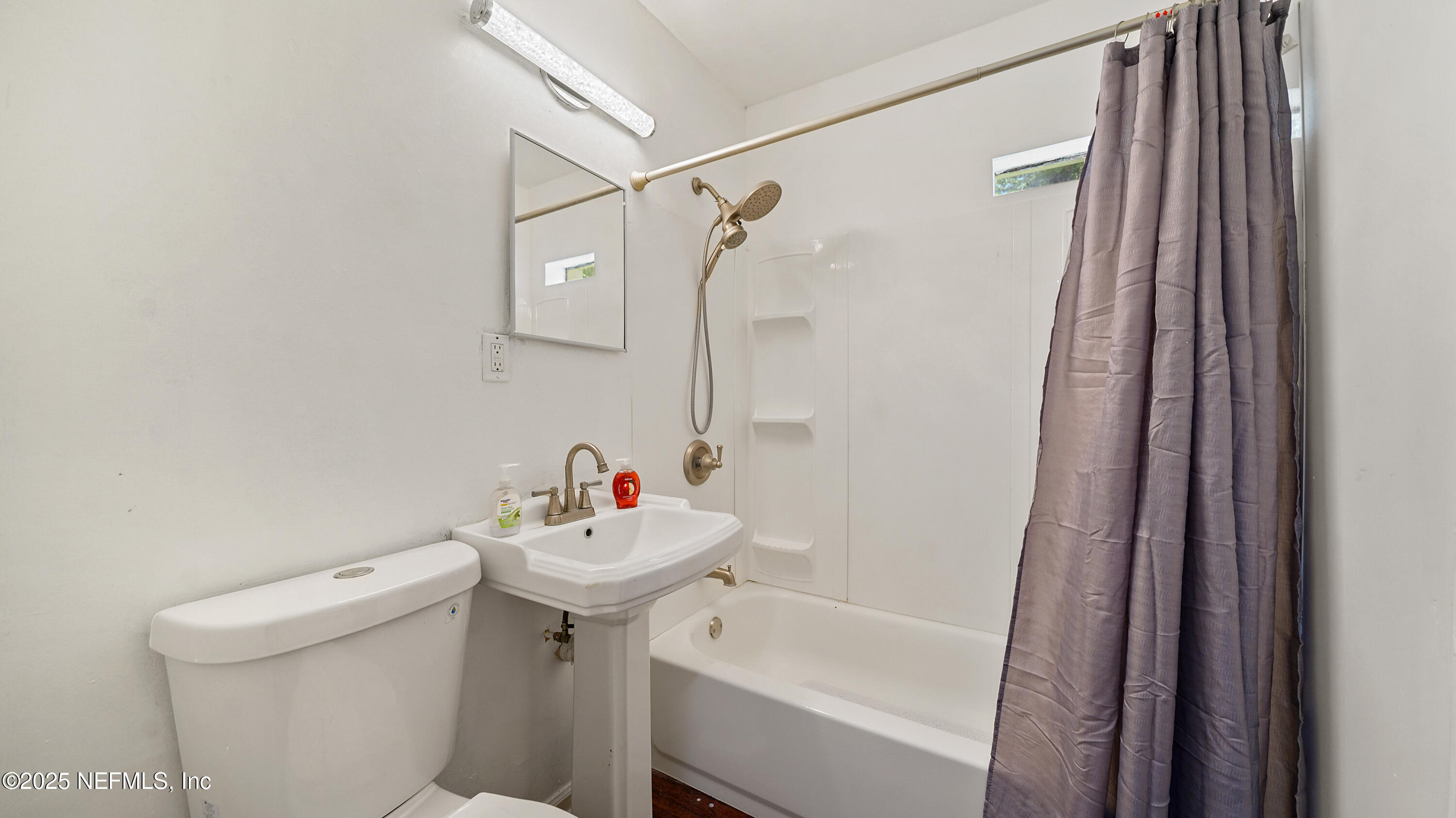 10555 Rutgers Road Jacksonville, FL 32218 - Photo 16 of 25 a bathroom with a sink a toilet and shower