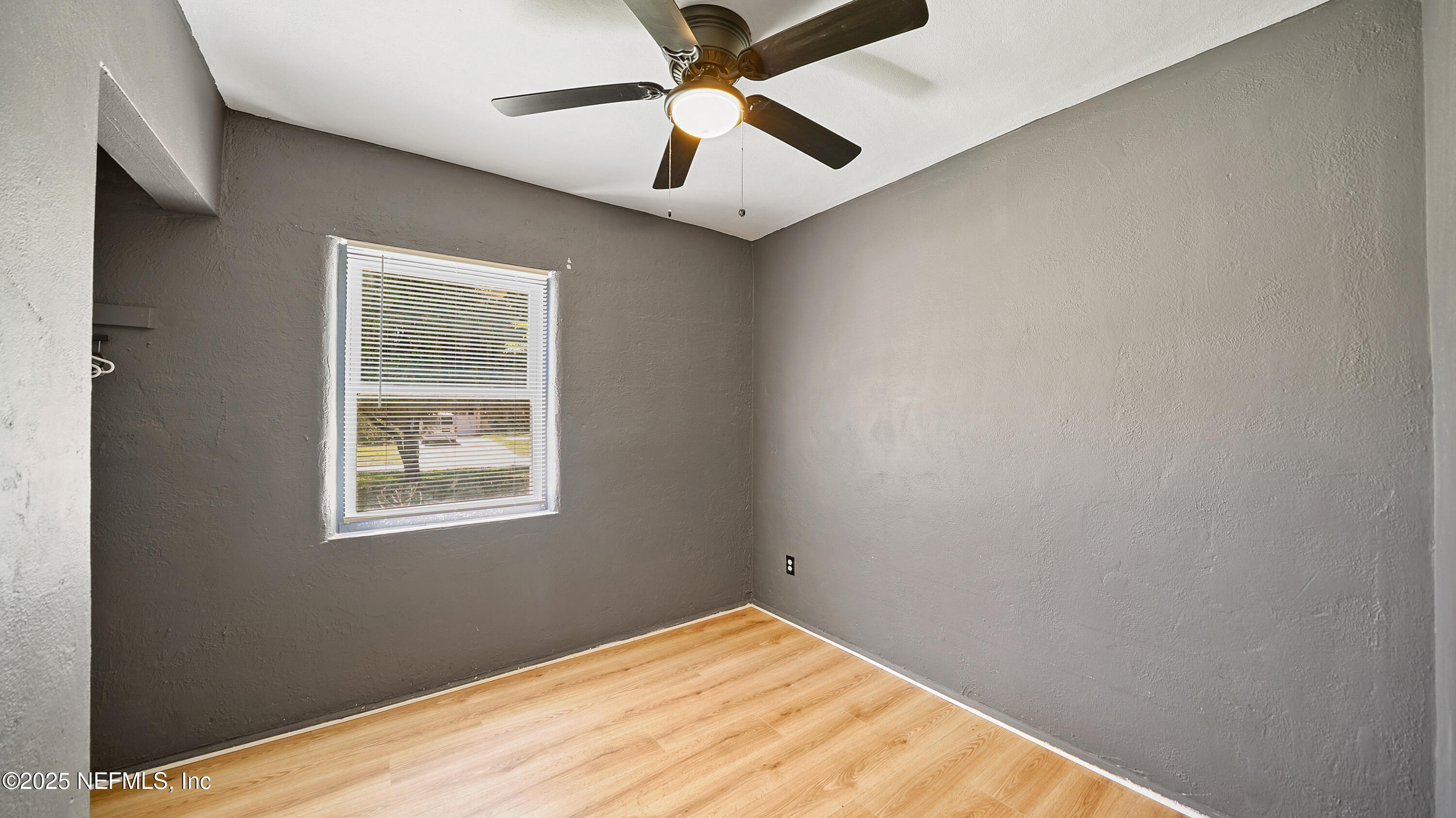 10555 Rutgers Road Jacksonville, FL 32218 - Photo 18 of 25 an empty room with windows and fan
