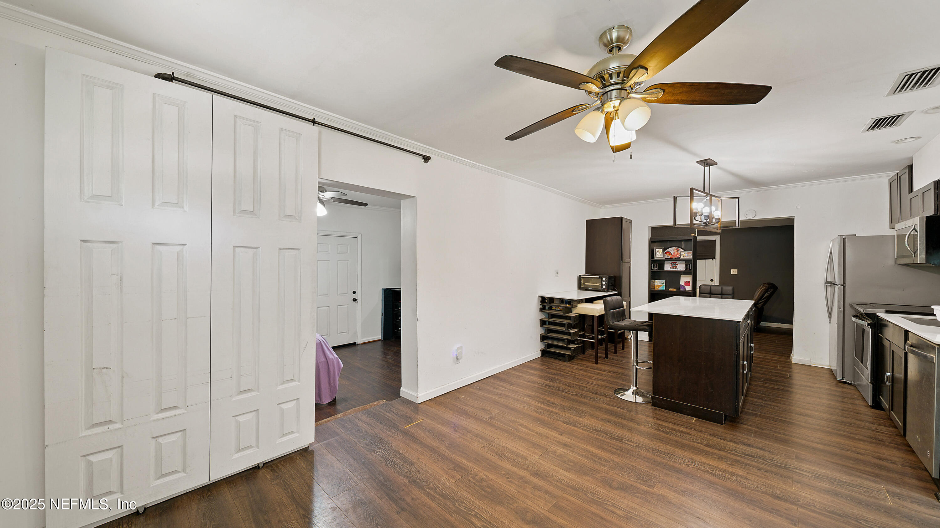 10555 Rutgers Road Jacksonville, FL 32218 - Photo 3 of 25 a view of a livingroom with furniture and chandelier fan