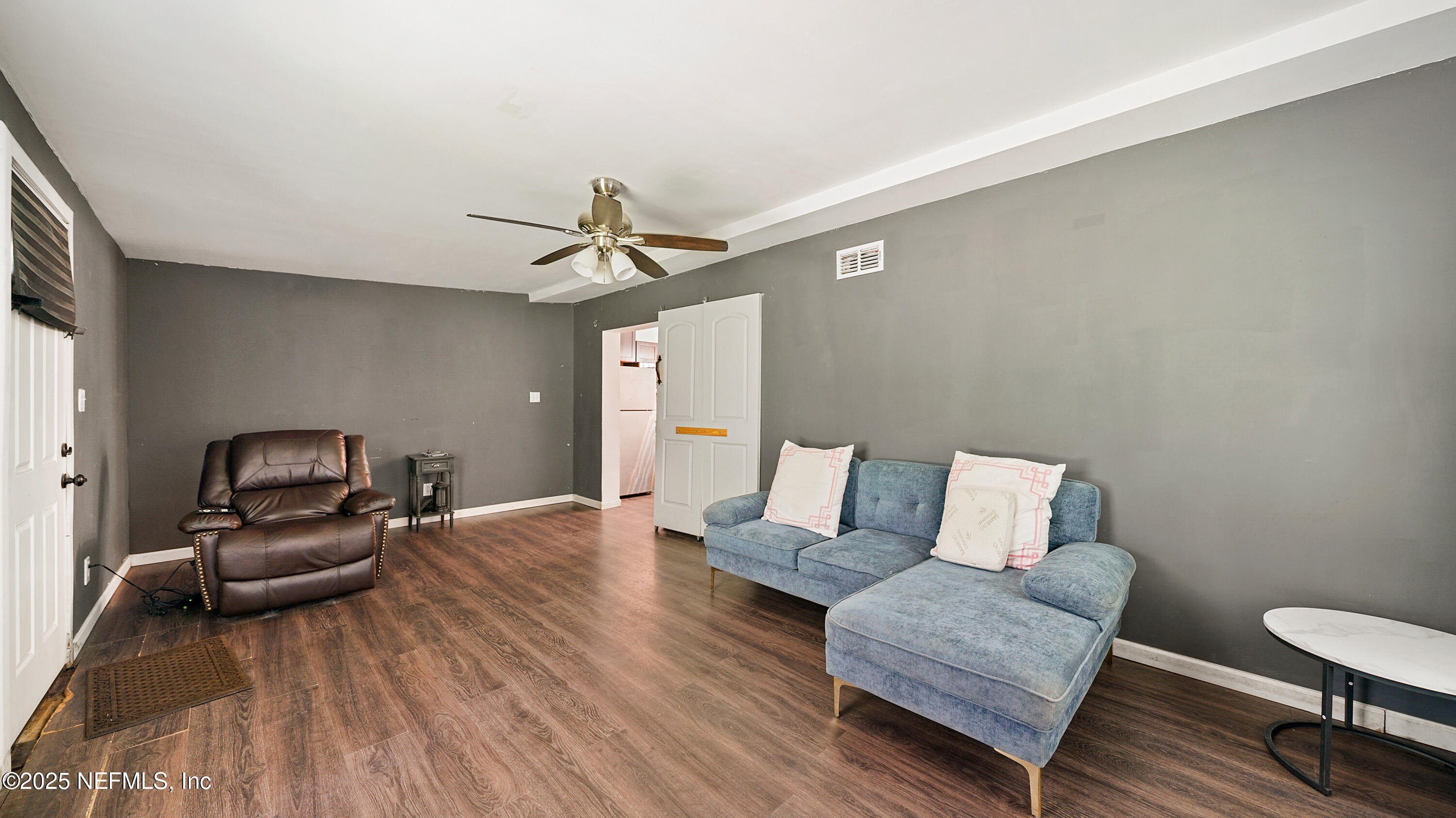 10555 Rutgers Road Jacksonville, FL 32218 - Photo 9 of 25 a living room with furniture and a wooden floor