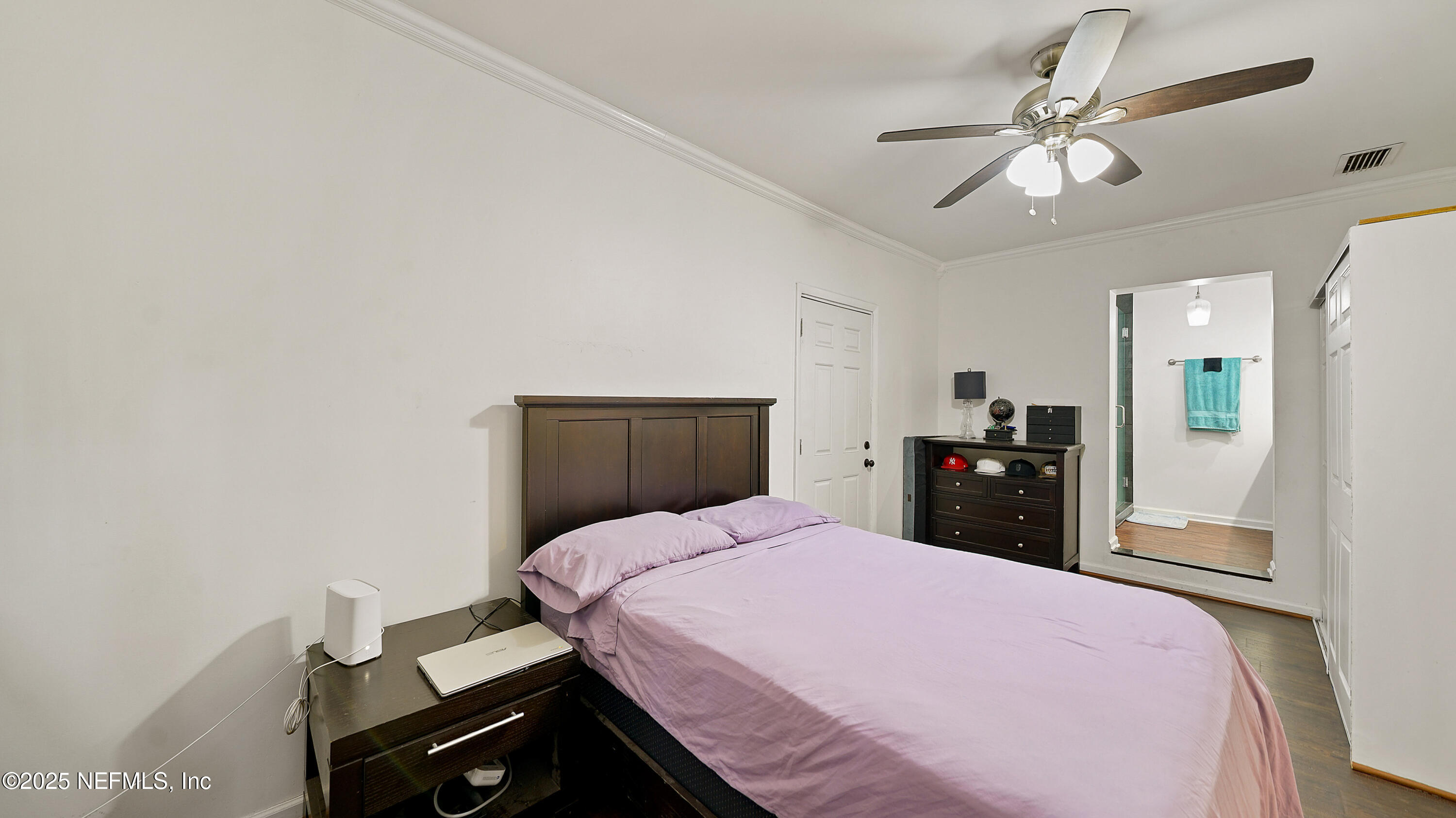 10555 Rutgers Road Jacksonville, FL 32218 - Photo 10 of 25 a bedroom with a bed and a chandelier