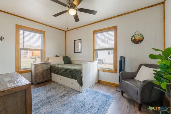 a spacious bedroom with a bed and a couch