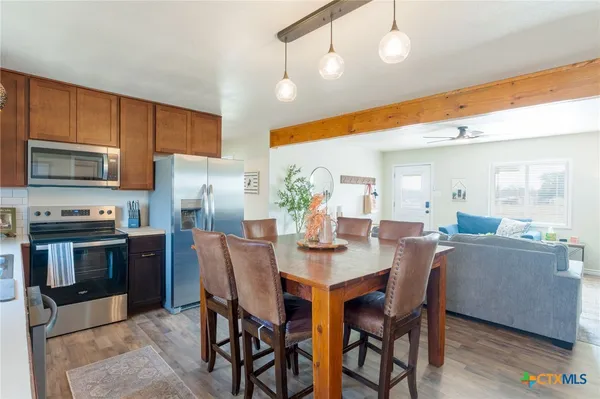a view of a dining room with furniture and wooden floor