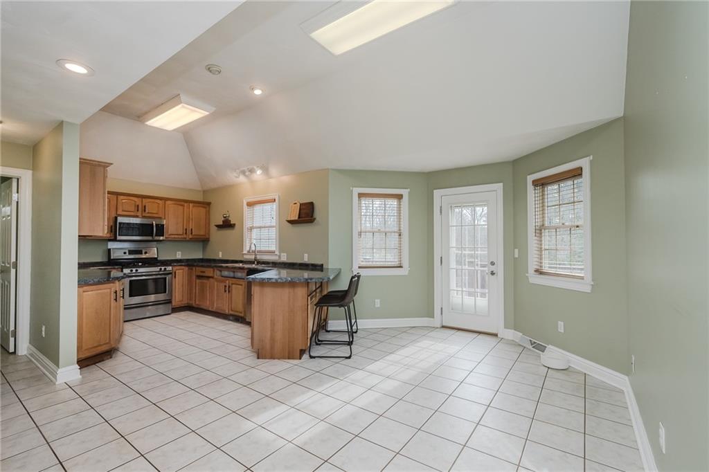 459 Forest Ridge Road Indiana, PA 15701 - Photo 12 of 45 a kitchen with stainless steel appliances granite countertop a stove top oven a sink and a refrigerator