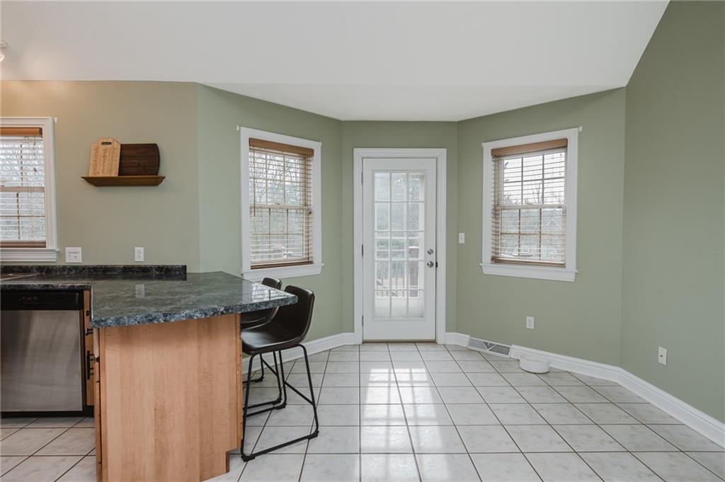 459 Forest Ridge Road Indiana, PA 15701 - Photo 13 of 45 a kitchen with granite countertop a sink a stove cabinets and a window
