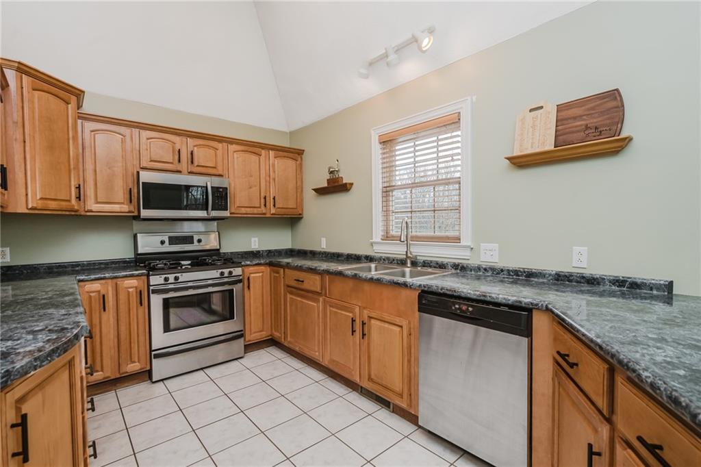 459 Forest Ridge Road Indiana, PA 15701 - Photo 14 of 45 a kitchen with granite countertop cabinets stainless steel appliances and a sink