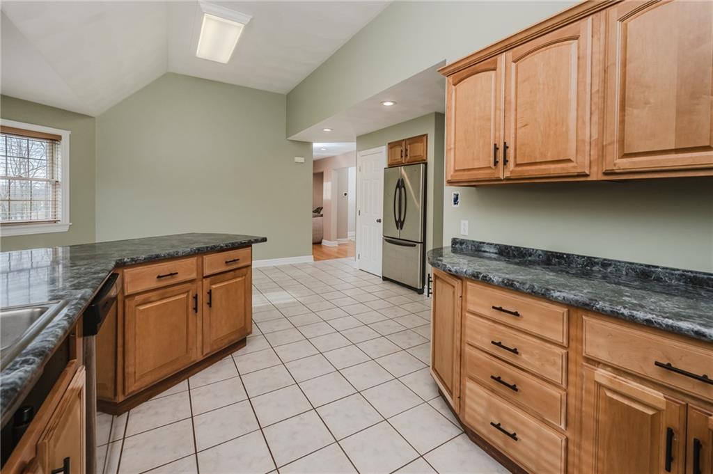 459 Forest Ridge Road Indiana, PA 15701 - Photo 16 of 45 a kitchen with granite countertop a stove top oven cabinets and a counter top space