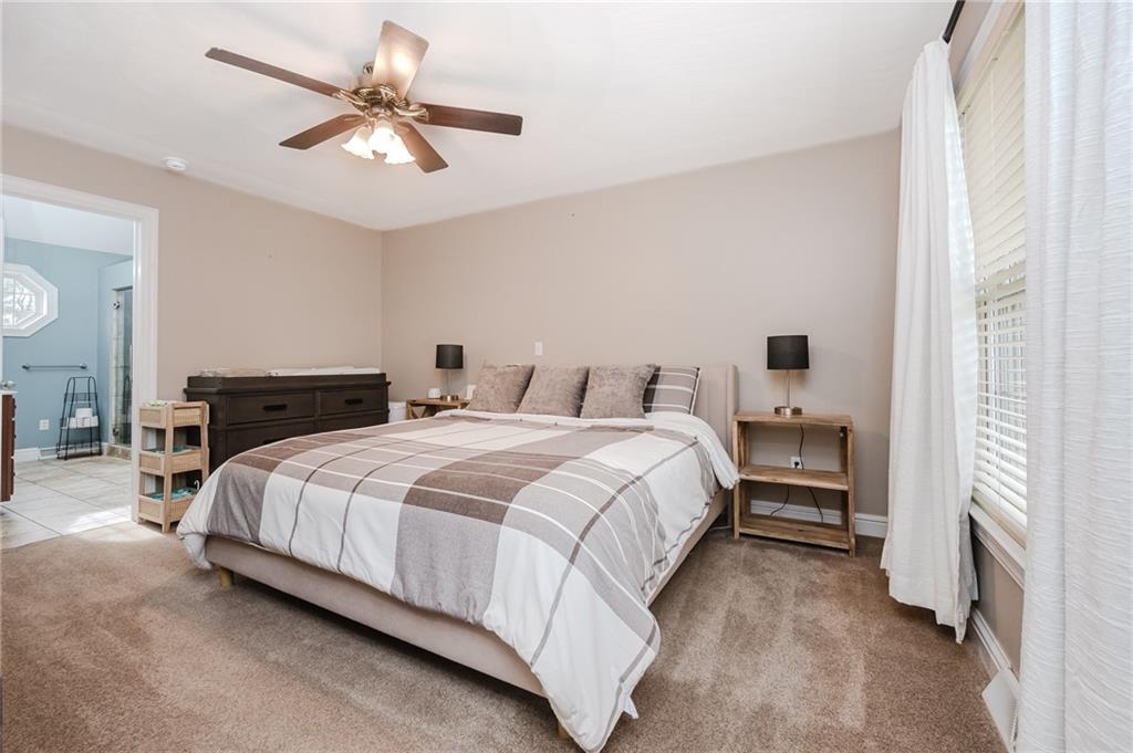 459 Forest Ridge Road Indiana, PA 15701 - Photo 19 of 45 a bedroom with a bed and a chandelier