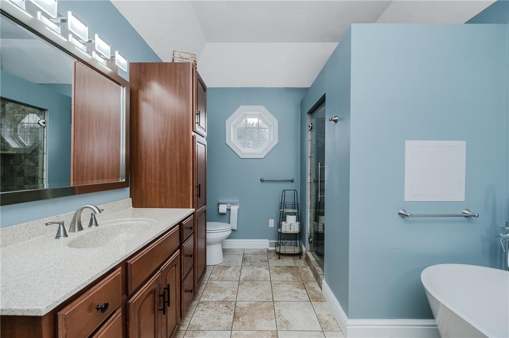 459 Forest Ridge Road Indiana, PA 15701 - Photo 22 of 45 a en suite bathroom with a double vanity sink toilet and a mirror
