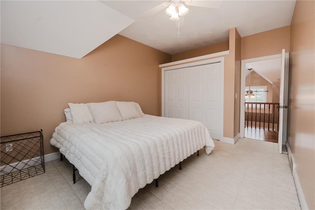 459 Forest Ridge Road Indiana, PA 15701 - Photo 32 of 45 a bedroom with a bed and a chandelier