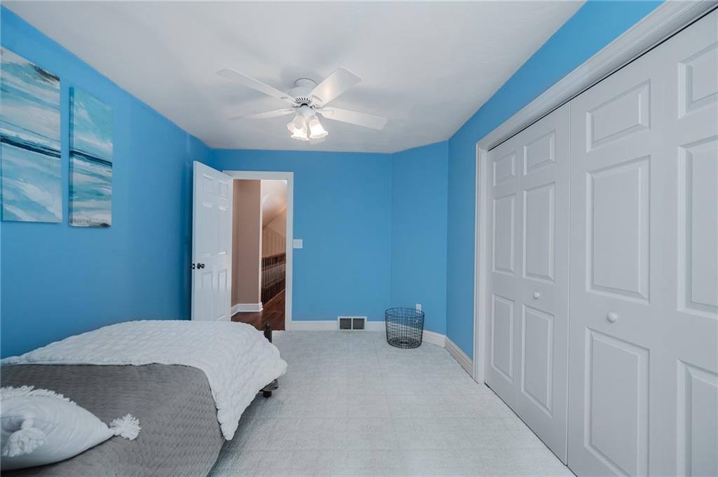 459 Forest Ridge Road Indiana, PA 15701 - Photo 34 of 45 a bedroom with a large bed and a chandelier fan