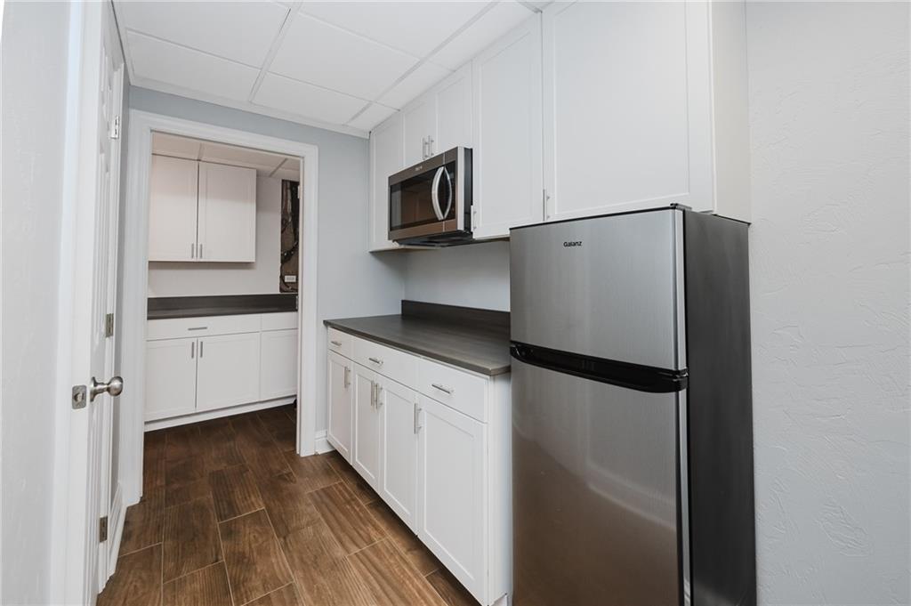 459 Forest Ridge Road Indiana, PA 15701 - Photo 40 of 45 a kitchen with stainless steel appliances a refrigerator a sink and white cabinets