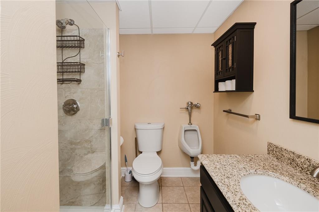 459 Forest Ridge Road Indiana, PA 15701 - Photo 42 of 45 a bathroom with a granite countertop toilet sink and shower