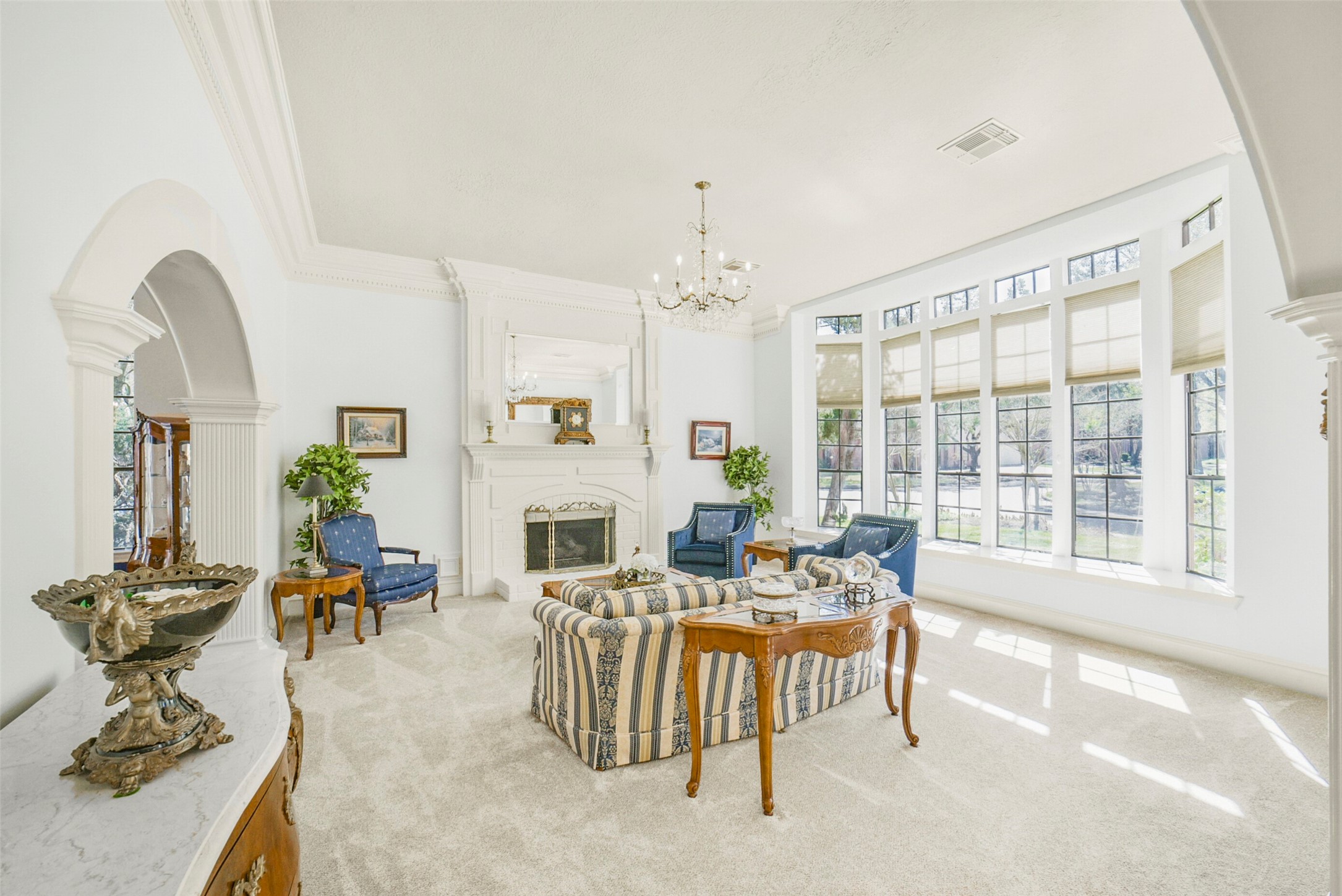 17302 Atherington Place Spring, TX 77379 - Photo 7 of 50 Sophisticated formal living with exquisite moldings, statement lighting, and a stunning fireplace creates a refined gathering space.