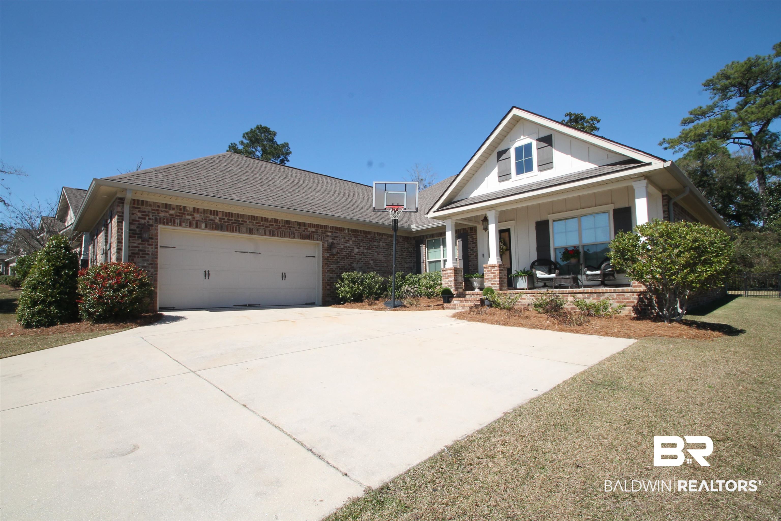 30232 Persimmon Drive Daphne, AL 36527 - Photo 1 of 27 View of front of property with an attached garage, concrete driveway, brick siding, and a porch