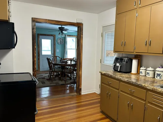 a living room with furniture ceiling fan and a window