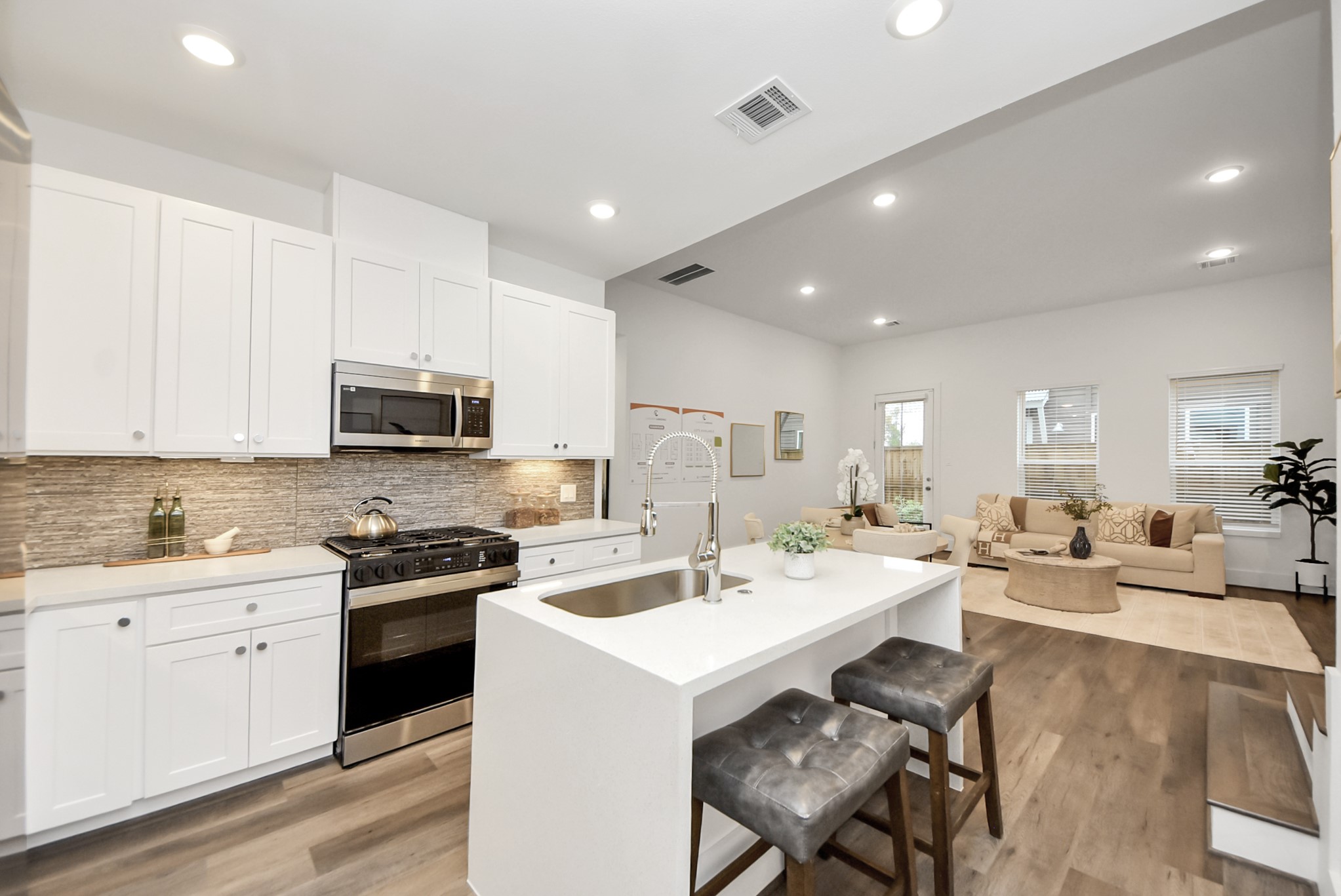 7502 Carver Road, Unit A Houston, TX 77088 - Photo 14 of 48 a kitchen with sink a microwave and cabinets
