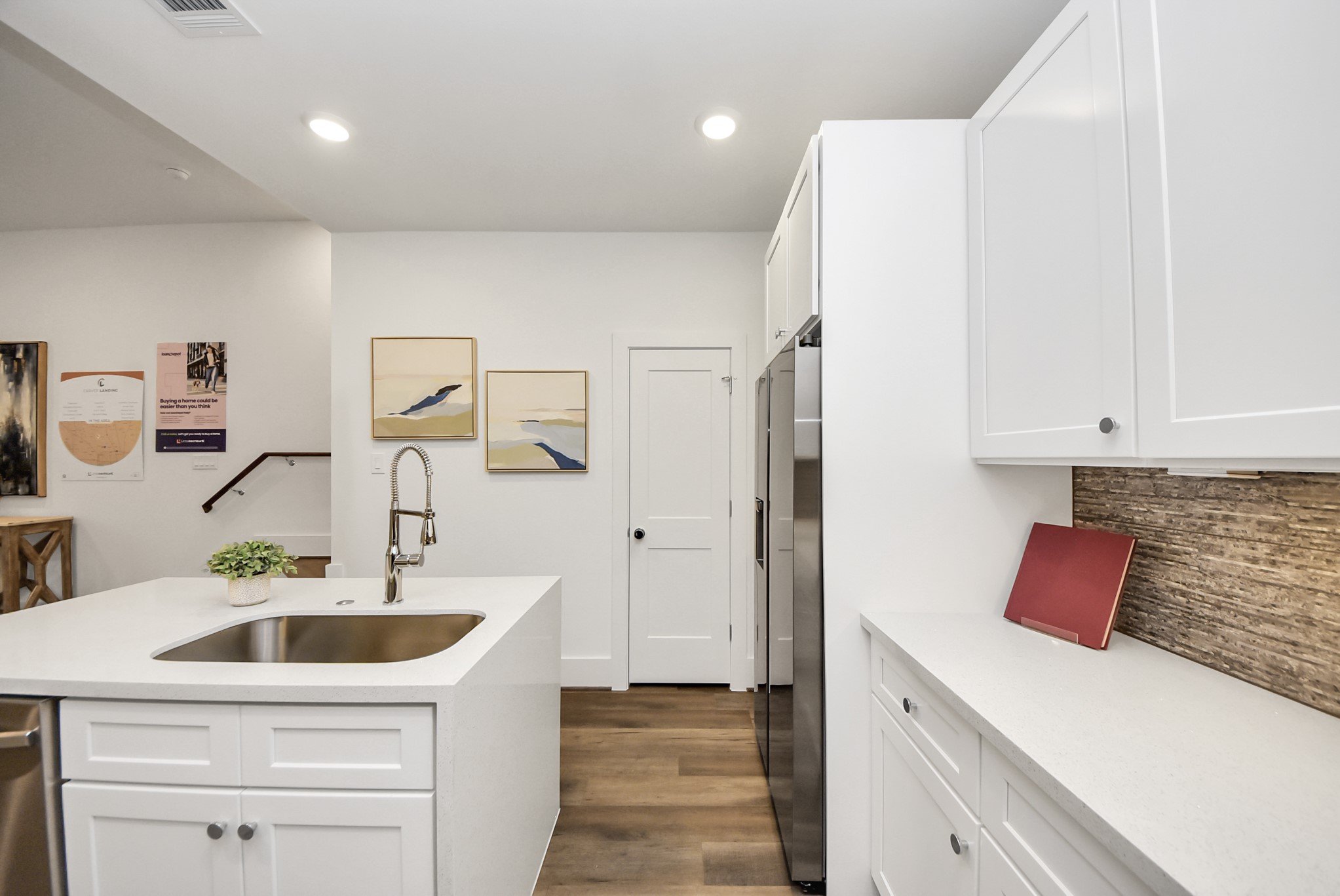7502 Carver Road, Unit A Houston, TX 77088 - Photo 17 of 48 a kitchen with stainless steel appliances a sink dishwasher and white cabinets with wooden floor