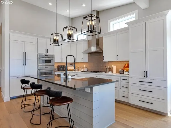 a kitchen with stainless steel appliances granite countertop a sink and cabinets