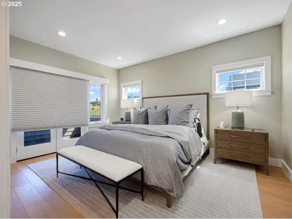 a spacious bedroom with a bed and a dresser