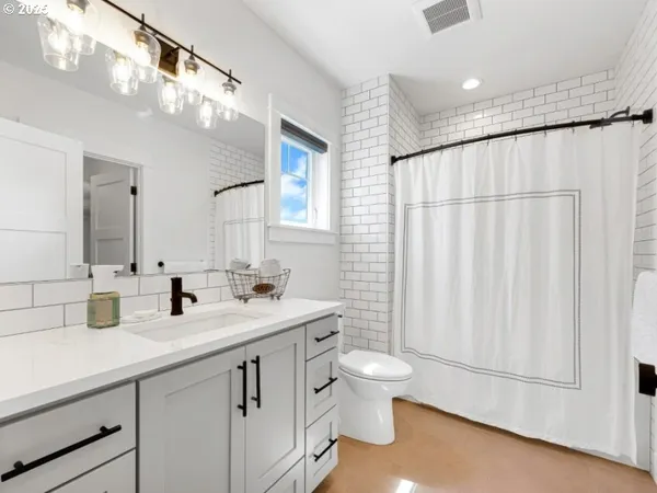 a bathroom with a toilet a sink and a mirror