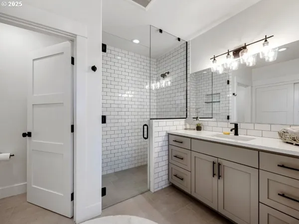 a spacious bathroom with double sink and a mirror