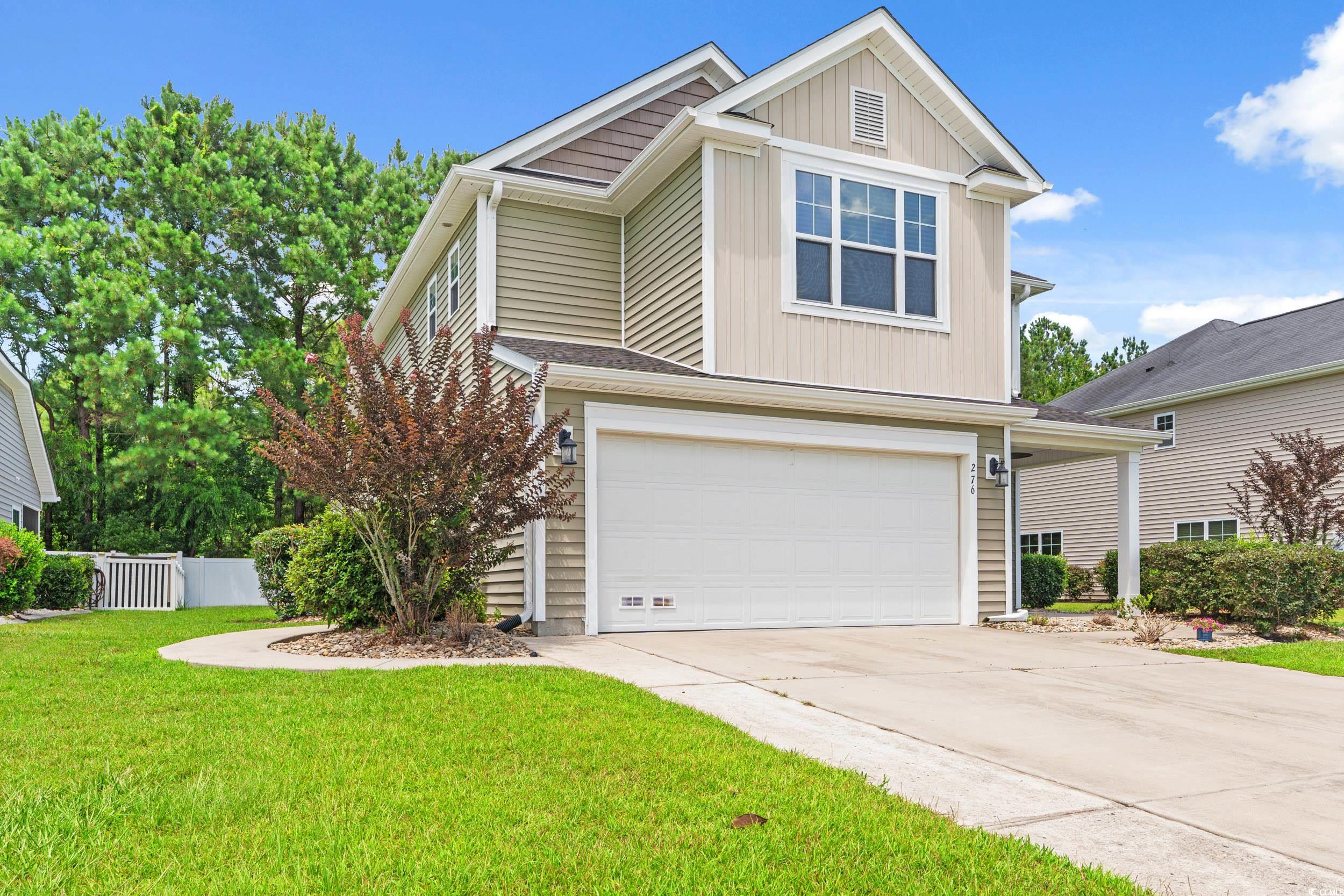 276 Whipple Run Loop Myrtle Beach, SC 29588 - Photo 1 of 40 View of front facade with an attached garage, conc
