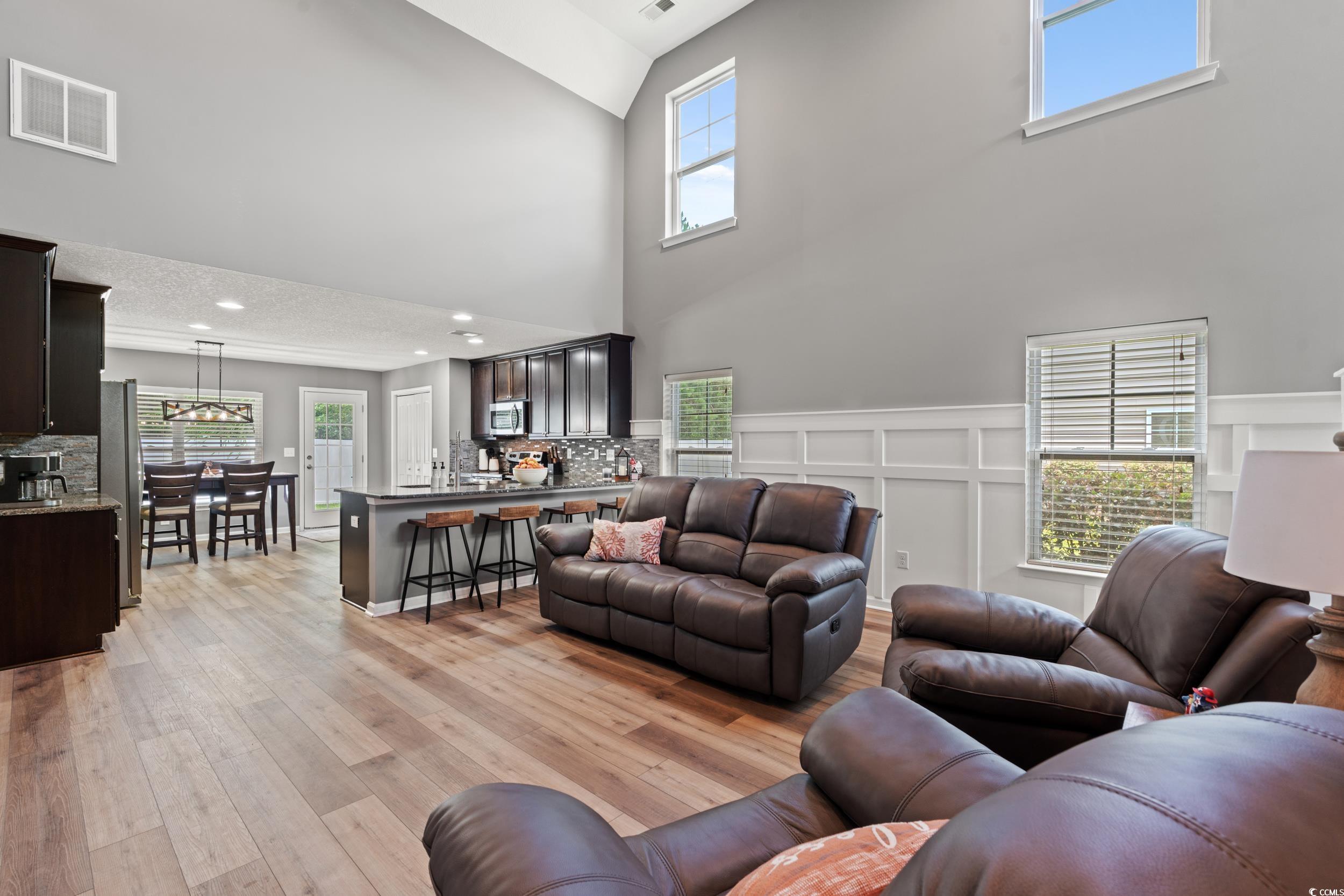 276 Whipple Run Loop Myrtle Beach, SC 29588 - Photo 13 of 40 Living area featuring a high ceiling, light wood f