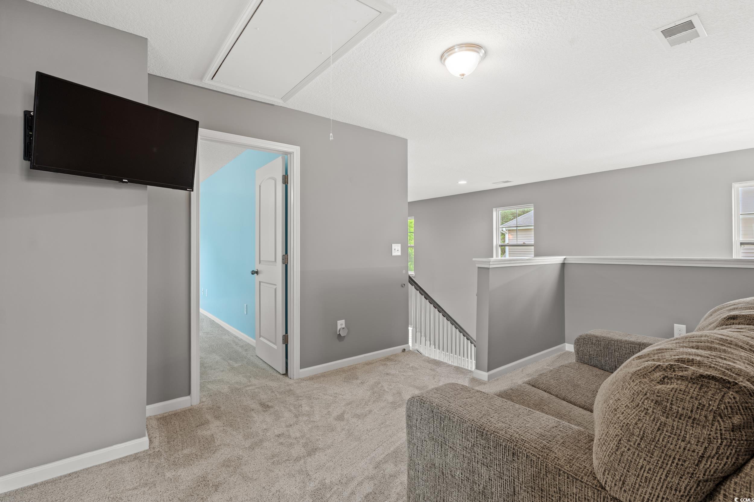 276 Whipple Run Loop Myrtle Beach, SC 29588 - Photo 28 of 40 Living area featuring attic access and carpet floo