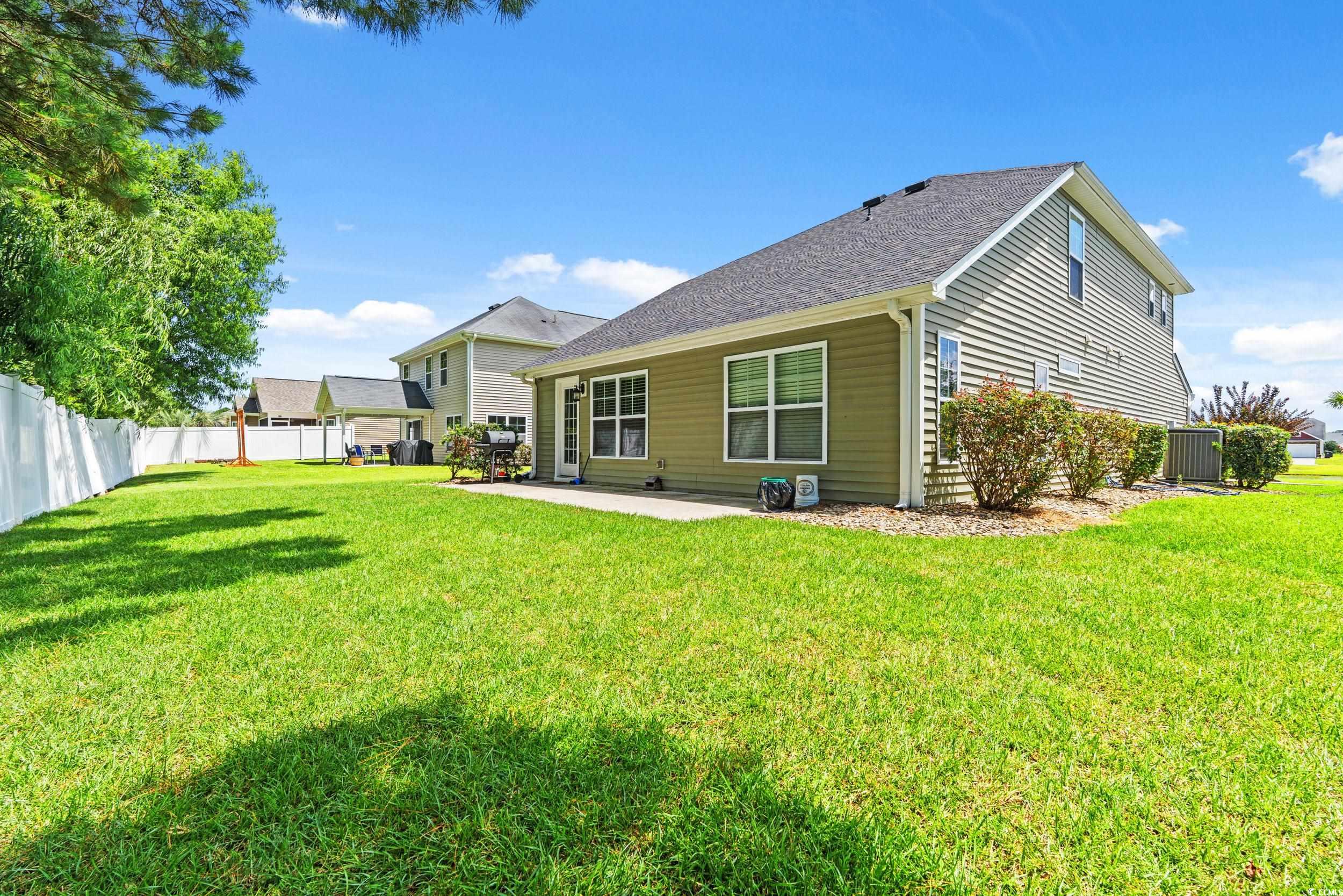 276 Whipple Run Loop Myrtle Beach, SC 29588 - Photo 4 of 40 Rear view of house with a patio and roof with shin